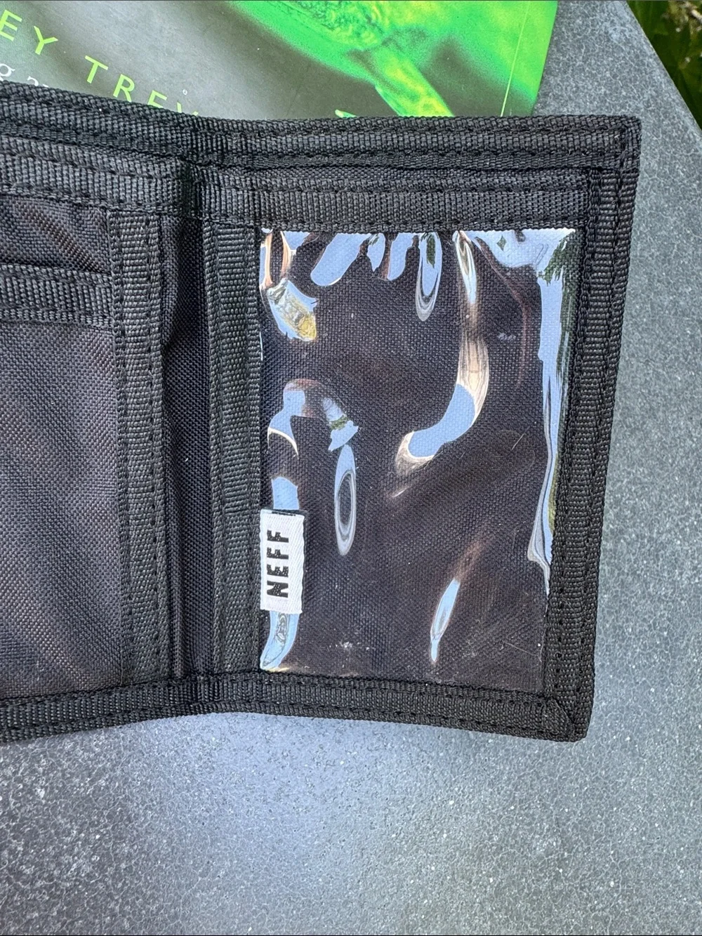 NWOT NEFF black background with tropical theme trifold wallet. Zipper pocket.
